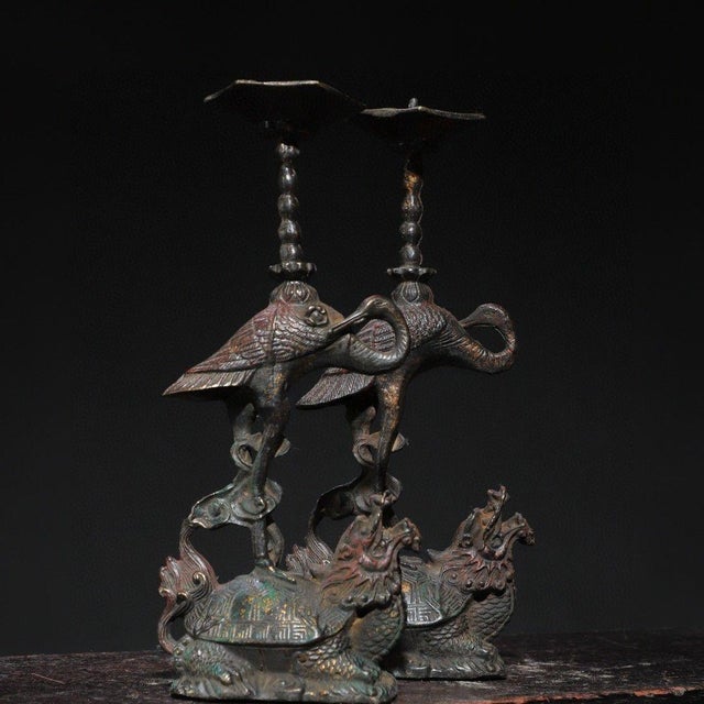 This is a rare and exquisite pair of antique Chinese bronze candle holders featuring a majestic red-crested crane standing...