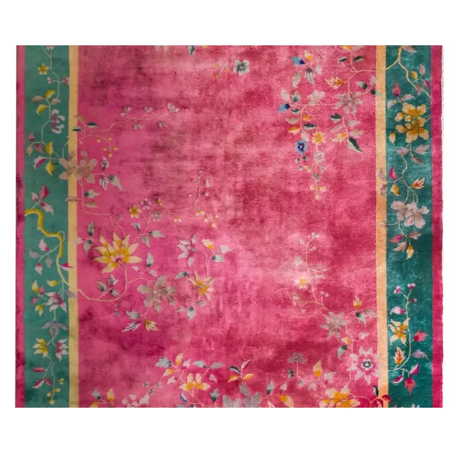 A beautiful early 20th century Chinese Art Deco rug with a brilliant fuchsia field surrounded by a wide turquoise border...