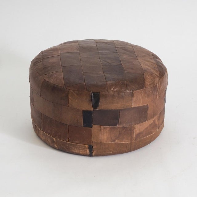 This vintage leather patchwork pouf brings tactile warmth and character to interior spaces. The classic cylindrical...