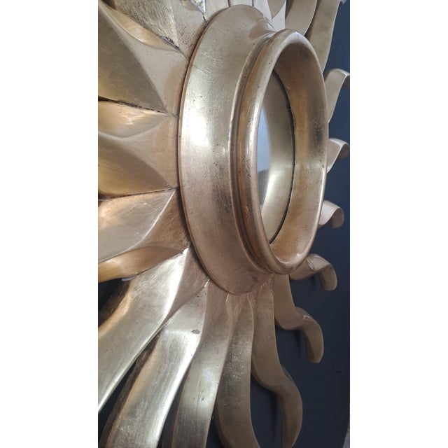 Hand-carved and gilded vintage mirror, crafted from wood and finished with traditional gold leaf techniques. It features...