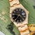 Rolex Oyster Perpetual Date featuring rare petroleum black gloss dial in 34mm 18K yellow gold case with engine-turned...