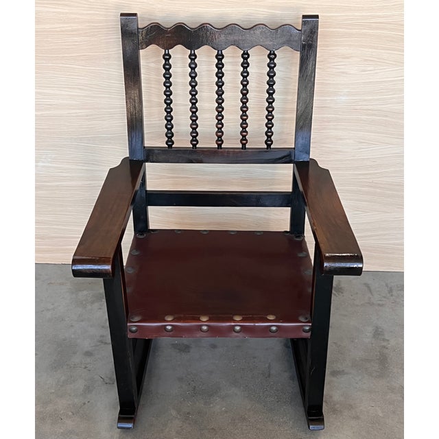 19th century walnut Spanish rocking armchairs with bars back and leather seat Measures: Height to arms 24.40 in....