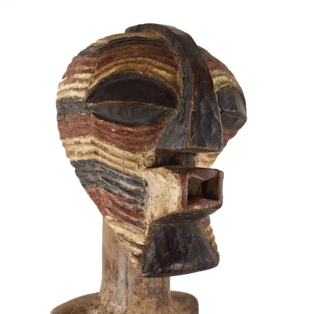 Unique and rare item! A standing Songye female power figure, known as Nkishi, exhibits a cylindrical neck, shoulders...