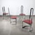 Set of four dining chairs with a flat-profile chromed steel frame and red lacquered wooden seats. The design emphasizes...