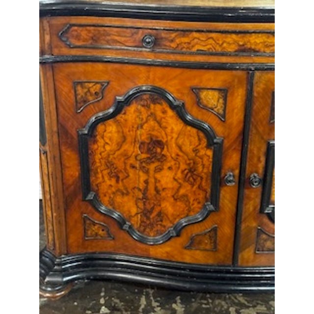 The 19th Century Italian Burl Walnut Buffet is a stunning piece of polished furniture that exudes elegance and...