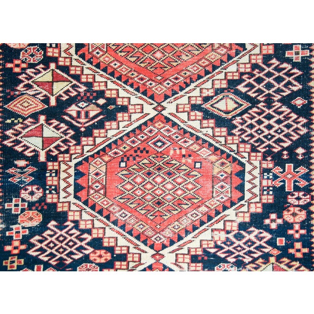 An exciting early 20th century Persian Shrivan rug with three large central diamond medallions with myriad stylized floral...