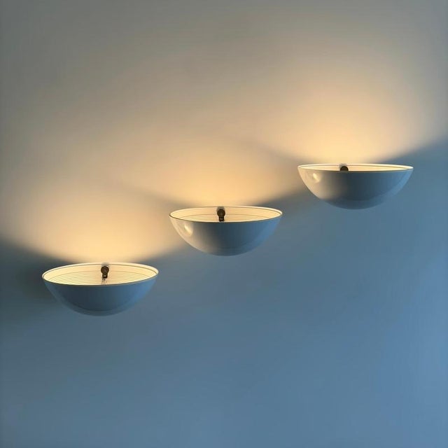 An exceptionally rare set of three Model 1222 wall sconces designed by Elio Martinelli for Martinelli Luce in 1979, an...