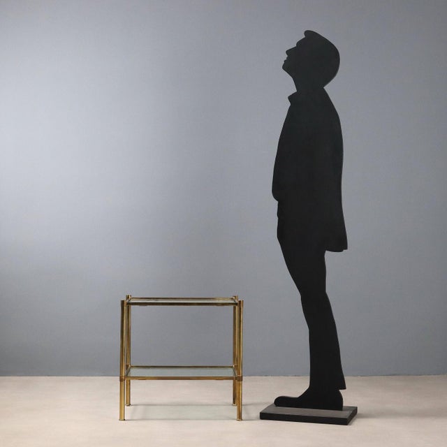 1970s vintage coffee table characterized by an essential and functional design. The structure is made of brass, giving it...