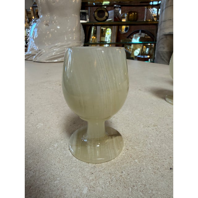 A beautiful set of six goblets crafted from natural marble, each showcasing unique veining and soft variations in tone....