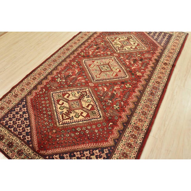 This authentic vintage tribal Qashqai rug is hand-knotted with an all-wool pile on a cotton foundation. This rug features...