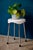 This tonic stool is a KSR stamped production. The seat is in molded plastic, ivory white. It is supported by 4 chrome...