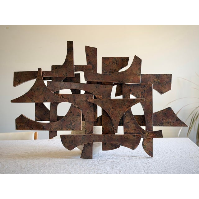 Vintage 1960s–1970s abstract wall sculpture with strong Brutalist influence, executed in a bronze-tone finish with layered...