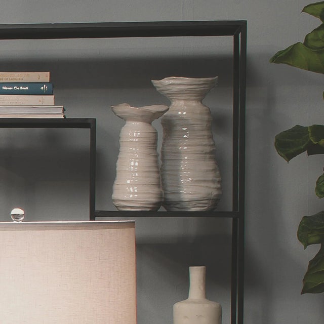 Resembling objects found on a seashore, this vase features a ribbed organic ceramic body and pearl cream glaze. Ideal for...