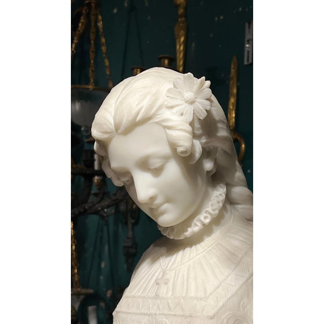 Magnificent white marble statue of an elegant woman pulling petals from a flower, as in the popular 19th century game, he...