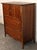 This elegant Mid-Century walnut highboy dresser by Harmony House features clean lines, sculpted drawer pulls, and a rich...