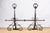 A set of wrought iron andirons, early 20th century, Italian. Featuring ball finials with operable rings (shown up in...