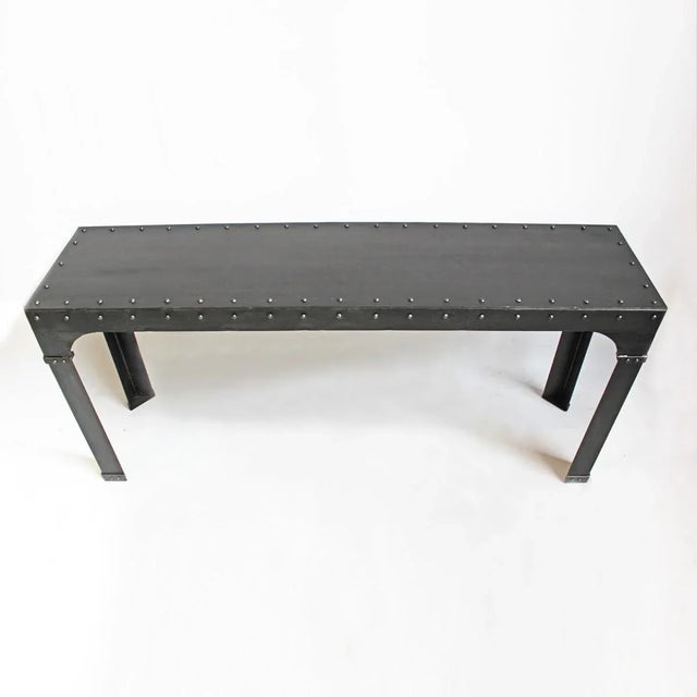 Blackened steel console table with iron rivet details. This is a wonderful industrial and modern piece.