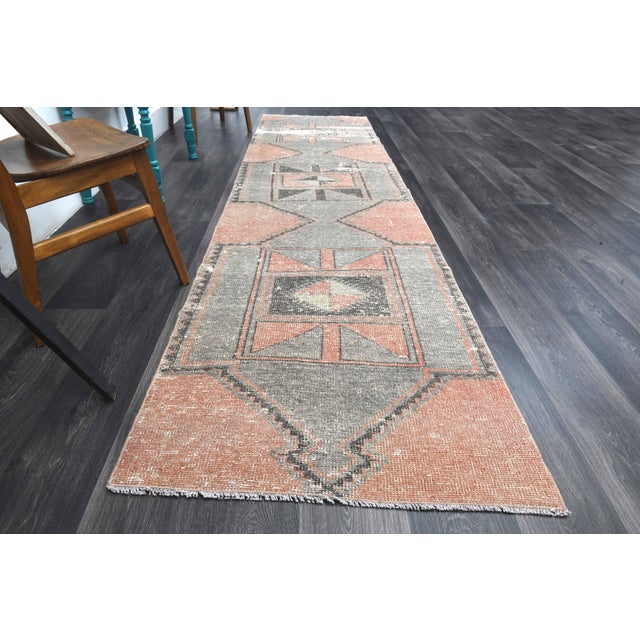 Vintage Hand-Knotted Runner rug is a semi-antique vintage runner rug. The '70s Eastern region of Anatolia's unique rug is...