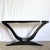 A striking example of late Art Deco–inspired craftsmanship, this sculptural console table features a dramatic curved...