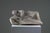 An elegant sculpture of a reclining female nude, crafted from reconstituted stone in the 1950s–1960s. This work fully...
