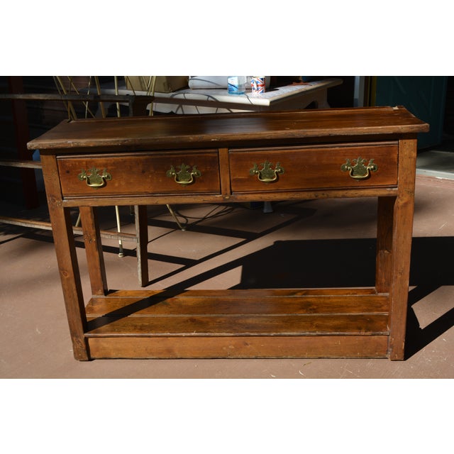This pine console /hall table, with removable plate rack, has had many years of use! Purchased in the UK. The plate rack...