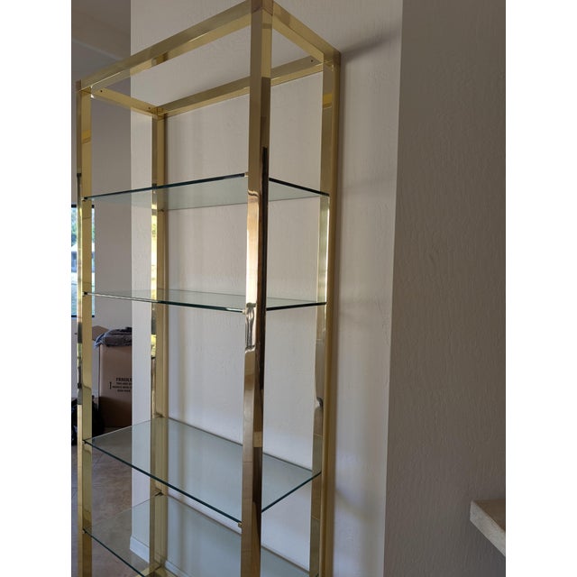 Hollywood Regency brass and glass etagere vintage late 70's. Excellent vintage condition. Glass shelves in excellent....