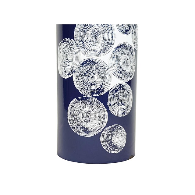 Cylindrical enameled metal umbrella stand in blue & black with white relief decoration. Good condition: some chips of...