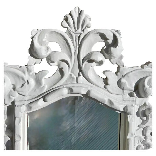 A dramatic and highly decorative Hollywood Regency white Rococo‑style wall mirror, crafted circa 1960s–1970s. This...