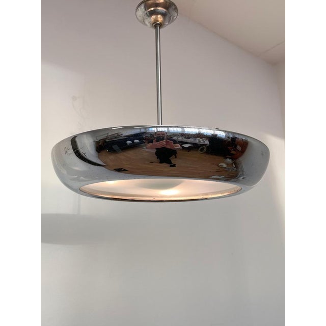 - chrome with patina - newly wired - polished - three bulbs any wattage - US compatible This piece is attributed to the...