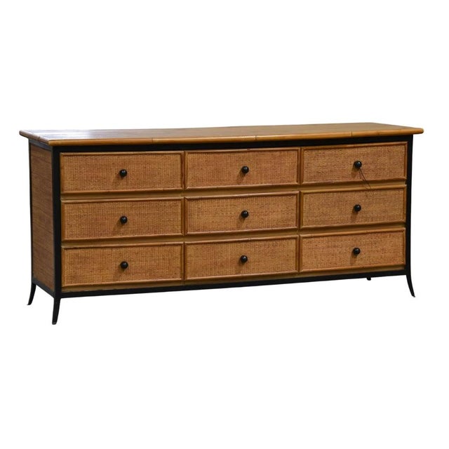 A Walters Wicker nine drawer dresser chest featuring woven rattan drawer fronts and side panels framed by warm bamboo-...