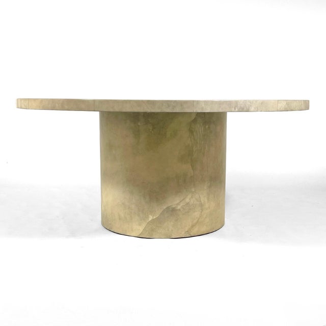 This large and dramatic dining table has a 5 1/2 foot top supported by a cylindrical base entirely covered in a faux...