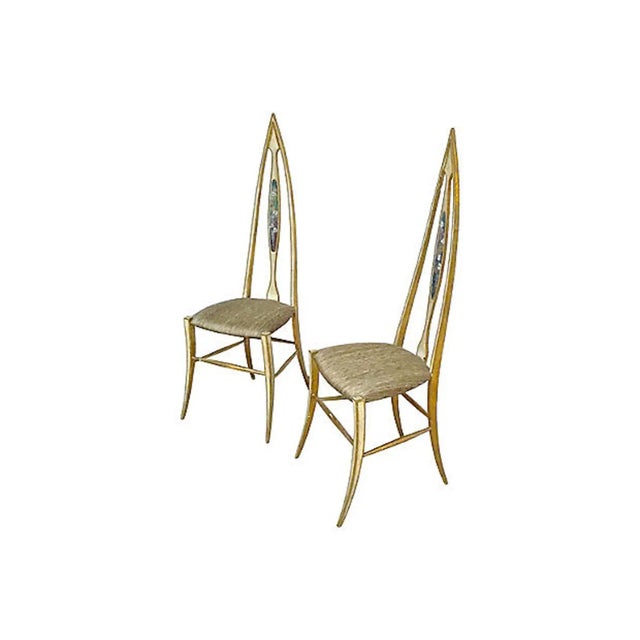 Pair of Mid-Century Modern abstract Florentine-style chairs with stylized gothic arched backrests and saber legs. Hand-...