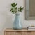 This Ceramic Vase Features A Striking Powder Blue Finish, Further Enhanced By Monochromatic Brushstrokes And A High-gloss...