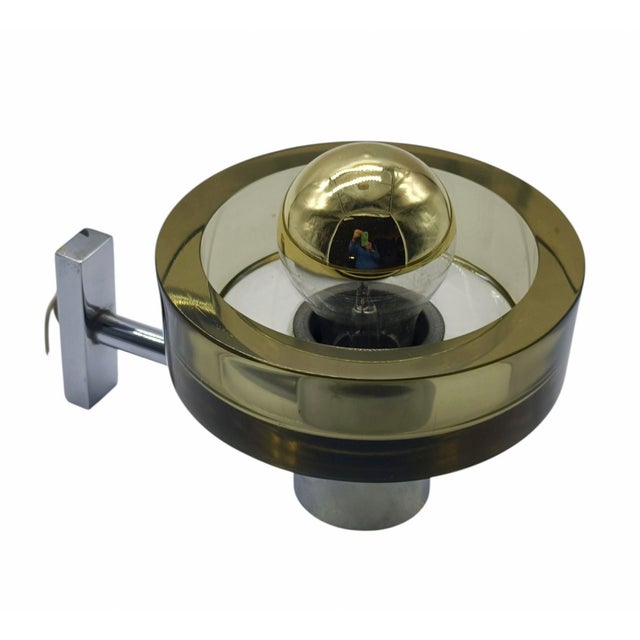 Wall lamp designed by Flavio Poli for Seguso in the 1960s. This wall lamp, with a chrome-plated metal frame, features a...