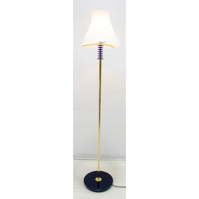 Floor lamp produced by Murano Auras, Murano jacketed glass, white and transparent, the structure is made of brass with...