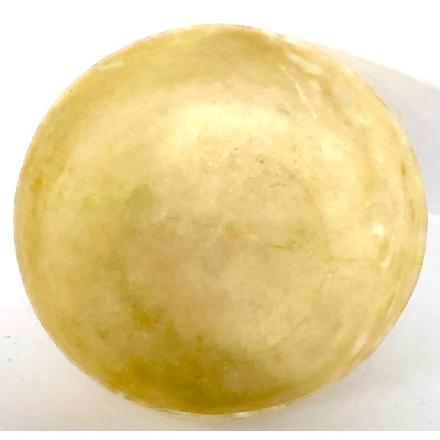 Beautifully carved stone bowl has a warm translucency when held up to the light.