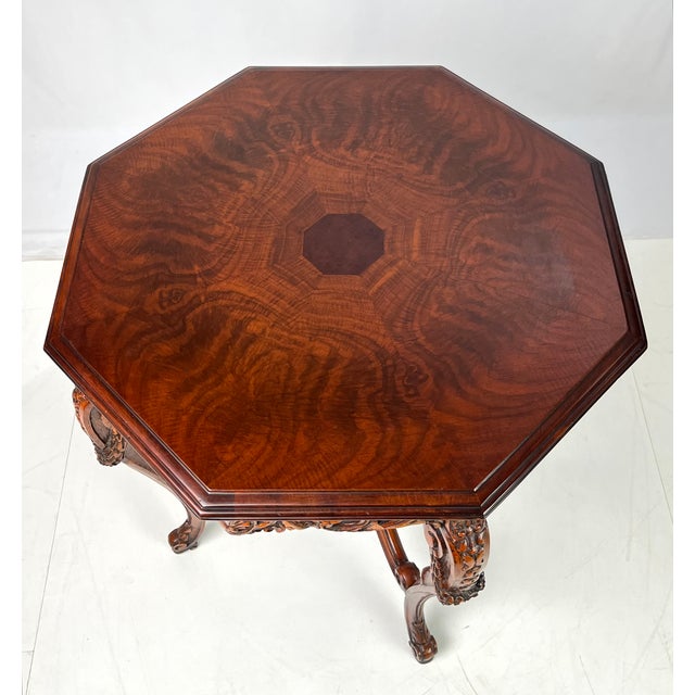 Beautiful Rococo Revival octagonal accent table crafted in rich walnut with book-matched burl wood veneering. The...
