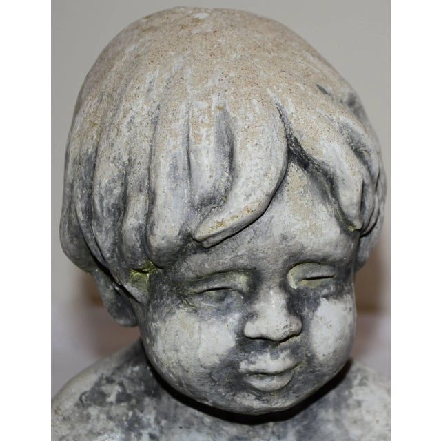 The child starring in this concrete statue will melt your heart. He is affectionately petting two little bunnies in his...