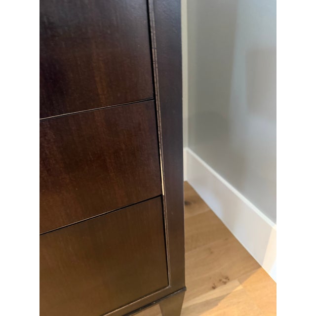 This tall tuxedo chest features dovetailed drawer construction and dark mahogany finish. Designed by renowned American...