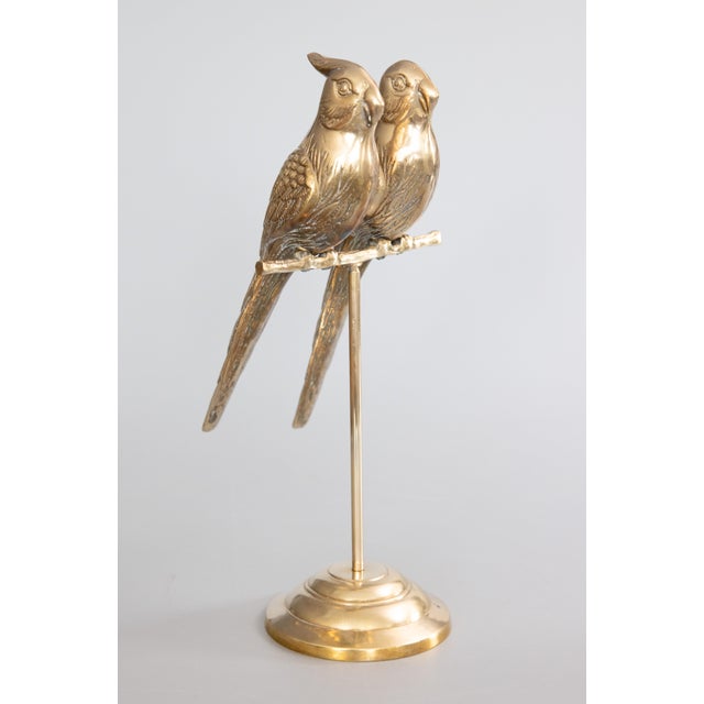 A stylish pair of vintage Mid-Century brass sculptural parrots or lovebirds perched on a stand with a lovely brass patina....