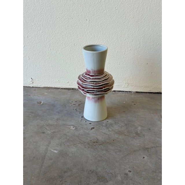 Beautiful mid-century modern ceramic vase featuring a sculptural layered-ring form at the center and a tapered top and...