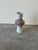 Beautiful mid-century modern ceramic vase featuring a sculptural layered-ring form at the center and a tapered top and...