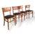 A stylish set of four mid-century dining chairs crafted from solid beech, featuring gently curved backrests and sleek...