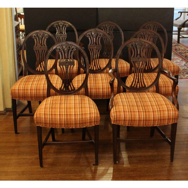 Circa 1860 set of eight George III style dining chairs, English. Two arms and six sides. Carved mahogany in the...