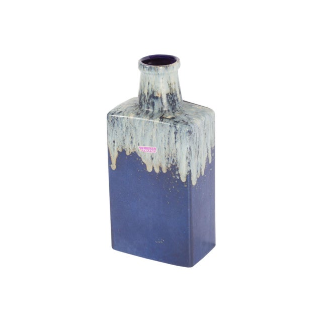 A West German ceramic vase produced by Scheurich Keramik. This mid-century vase has a bottle shape and is blue with a gray...