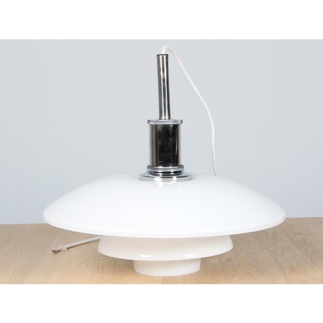 Poul Henningsen pendant lamp in chrome and opal glass. Model 4½/4, made by Louis Poulsen. This piece is attributed to the...