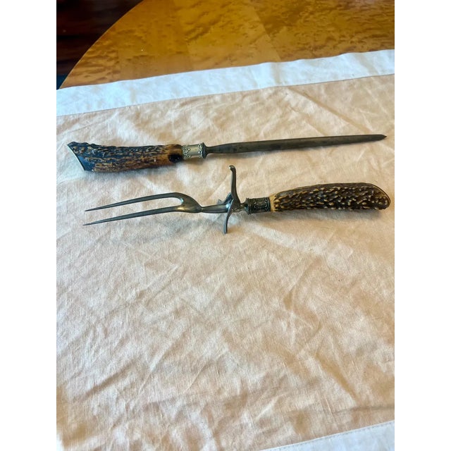 Antique 19th Century Victorian era meat carving fork and sharpening steel with stag horn handles and sterling silver...