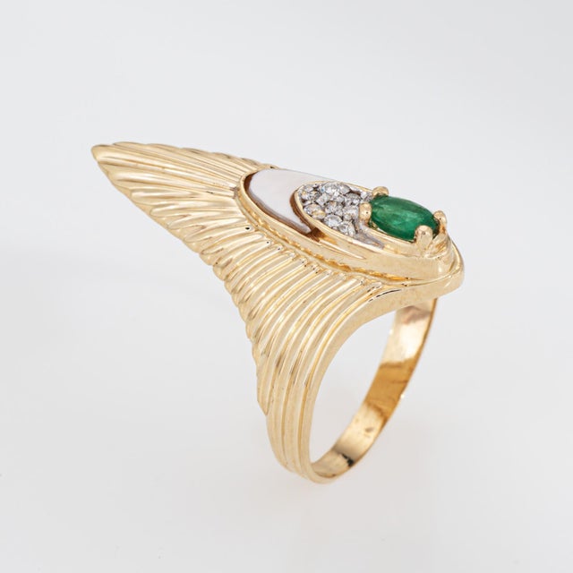 Vintage Erte peacock "Rayonnement" (radiance) emerald & diamond ring crafted in 14k yellow gold (circa 1970s). Oval cut...