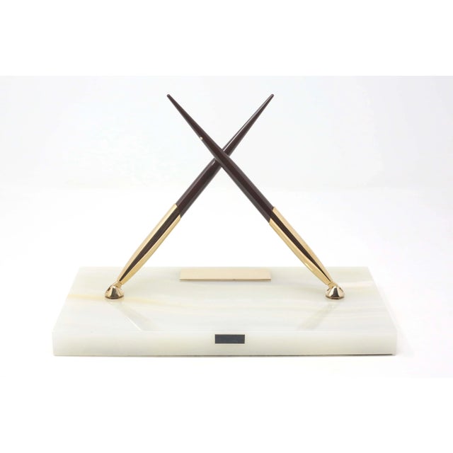 A vintage Sheaffer desk set, made with a polished slab of white stone, which holds two gold cradles for for the included...