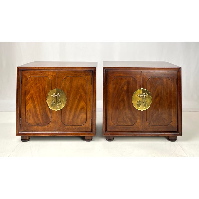 Striking pair of vintage bedside cabinets featuring classic Asian-inspired design details, highlighted by rich walnut...